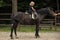 Equine therapy, recreation concept. Girl ride on horse on summer day