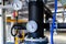 The equipment of the boiler-house, valves, tubes, pressure gauges, thermometer. Close up of manometer, pipe, flow meter, water