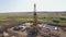 Equipment of oil well in field, top view from drone