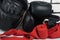 Equipment and things for boxing and martial arts lies on a gray floor against a white brick wall, close-up