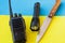 Equipment for trekking. Set of traveler or tourist or soldier. Radio for communication, knife, flashlight on a blue and yellow