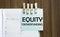 Equity Crowdfunding notes paper and a clothes pegs on wooden background