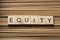 EQUITY word written on wooden cubes. Finance Concept. Money