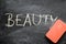 Erasing beauty, hand written word on blackboard being erased