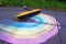 Erasing chalk colorful rainbow with broom.