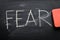 Erasing fear, hand written word on blackboard being erased