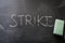 Erasing strike, hand written word on blackboard being erased concept