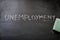 Erasing unemployment, hand written word on blackboard being erased concept