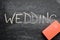 Erasing wedding, hand written word on blackboard being erased