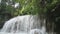 Erawan waterfall in the rainy season with turbid water with green forest