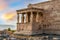 Erechtheion Temple Erechtheum with the figures of Caryatids at the archaeological site of Acropolis in Athens, Greece at sunset
