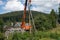 Erecting crane ready to dismantle the old wooden transmission tower on the outskirts of the village