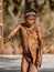 Erindi, Namibia / July 19, 2018: A native bushman gives a farewell dance to wish good hunting to the photographers