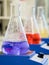Erlenmeyer flasks with colorful solutions