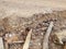 Eroded dirt path with bricks and masonry underneath