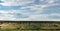 Eroded hill structure, agricultural field in steppe.