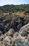 The eroded schists form sharp blades and deep drops in the rocks