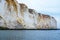 Eroding chalk white cliffs with a landslide at the bottom