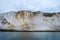 Eroding chalk white cliffs with a landslide at the bottom