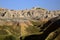 Eroding peaks and yellow mounds of the Badlands National Park So