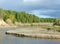 Erosion erosion of the sandy shore of a small Northern Yakut river in the wild Northern taiga