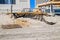 Erosion of the sand of the beach with destruction of a asphalt path after a hurricane and storm. There are large buildings in the