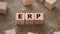 ERP abbreviation made of wooden cubes standing on burlap canvas. Business concept
