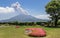 Erupted Vulcan Sakurajima covered by green Landscape. Taken from the wonderful Sengan-en Garden. Located in Kagoshima, Kyushu,