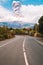 Eruption of the Etna volcano on the horizon of the lonely road on Sicily