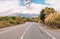 Eruption of the Etna volcano on the horizon of the lonely road on Sicily.