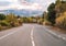 Eruption of the Etna volcano on the horizon of the lonely road on Sicily