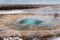 The eruption of the Strokkur geyser in the southwestern part of Iceland in a geothermal area near the river Hvitau