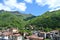 Erve valley near Lecco and lake Como and village in it under blue sky and cloudscape.