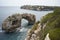 Es Pontas in Mallorca with boat anchored nearby in the Mediterranean sea. Majorca Sunrise with yacht and rock arch near Santanyi.