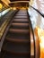 Escalator in the big shopping center in the movement