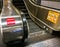 Escalator showing ` Emergency stop button ` and Caution Sign.