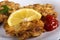 Escalope or schnitzel with ketchup or tomato sauce and lemon