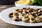Escargots de Bourgogne. Snails with herbs and garlic butter on a plate.