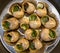 Escargots de Bourgogne- snails stuffed with herbs and oil. An exquisite French dish of fried snails.