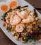 Esculentum Vegetable fern spicy salad with eggs and shrimp in coconut milk topping with peanut.