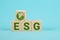 ESG concept of environmental, social and governance. ESG Words on a wood cubes. Wooden cube with abbreviation ESG on