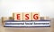 ESG environmental social governance symbol. Wooden cubes on book with words ESG environmental social governance. White background