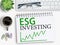 ESG investing results sign on notebook with keyboard and coffee,smartphone,glasses on office desk