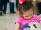 Eskisehir, Turkey - May 05, 2017: Sweet little girl caressing a lamb at the animal days event in the kindergarten.