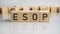 esop text on a wooden blocks, gray background.