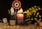 Esoteric and occult still life with vintage magic objects, runes and burning candle on witch table altar for mystic rituals and