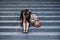 Esperate business woman crying alone sitting on street staircase suffering stress and depression crisis being victim of mobbing or