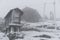 Espigueiro traditional structure for corn storage on a snow white winter landscape with snow falling in the north of Portugal