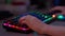 An esports player plays games on a gaming keyboard and mouse with RGB backlight