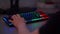 An esports player plays games on a gaming keyboard and mouse with RGB backlight